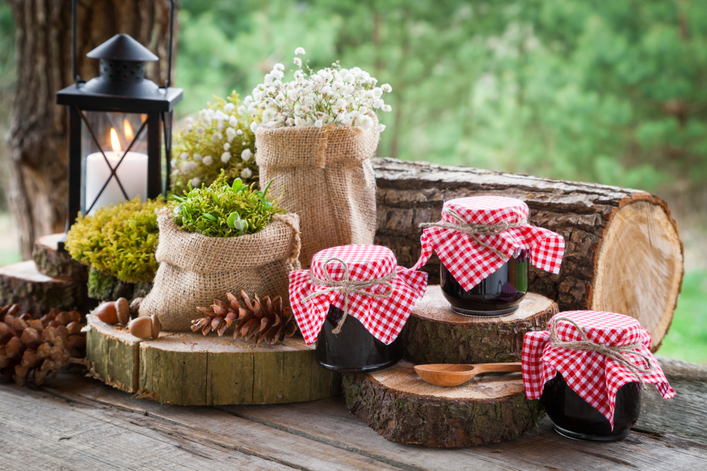 rustic decor with logs and mason jars with wildflowers arranged