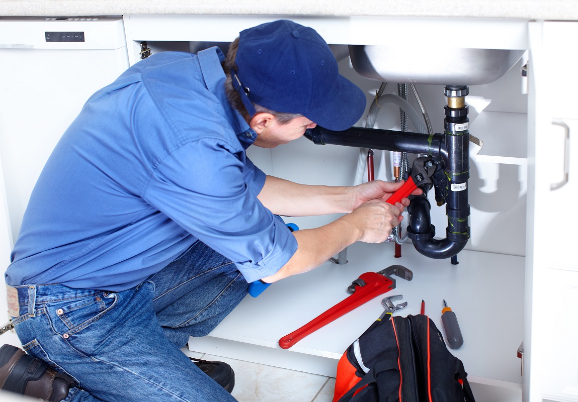 plumber fixing kitchen sink